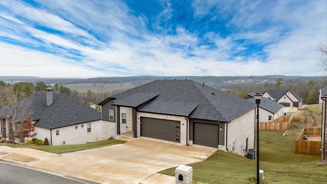 view of front of home featuring cooling unit, a garage, and a front lawn