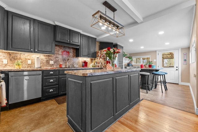 kitchen featuring light hardwood / wood-style flooring, dishwasher, hanging light fixtures, backsplash, and a kitchen island