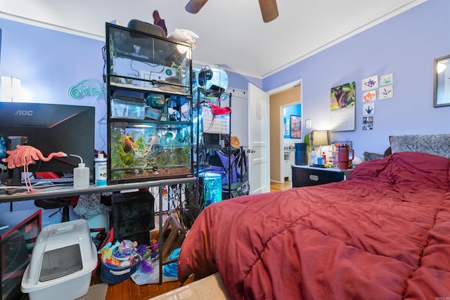 bedroom with crown molding, wood-type flooring, and ceiling fan