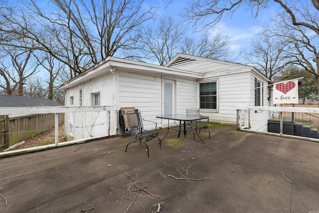 back of house featuring a patio and fence