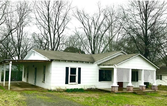 back of house with a carport