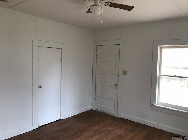 interior space featuring ceiling fan, plenty of natural light, and dark hardwood / wood-style floors