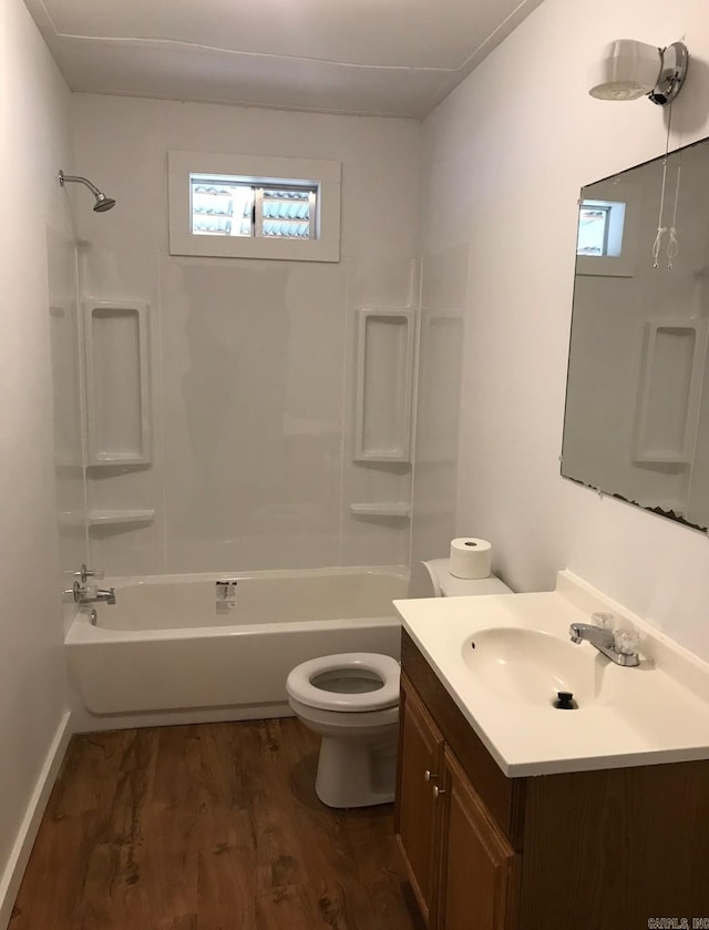 full bathroom featuring vanity, hardwood / wood-style flooring, bathing tub / shower combination, and toilet