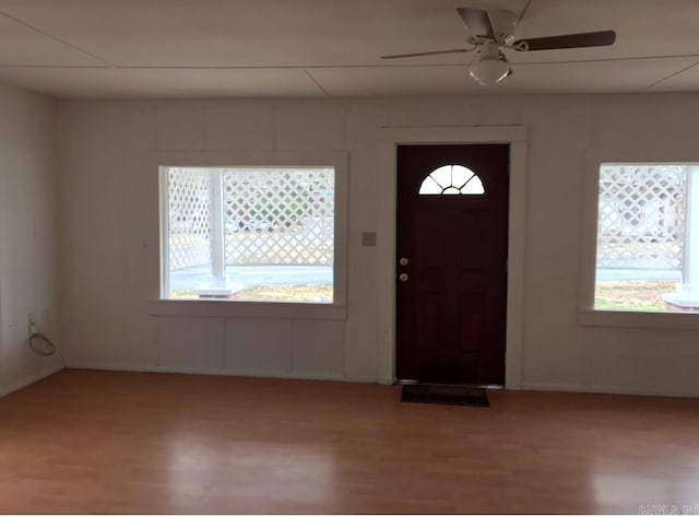 foyer entrance with ceiling fan and light wood-type flooring