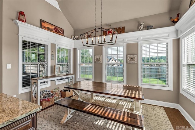 sunroom featuring lofted ceiling and a notable chandelier