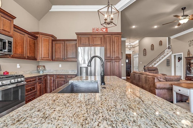 kitchen featuring stainless steel appliances, light stone countertops, and sink