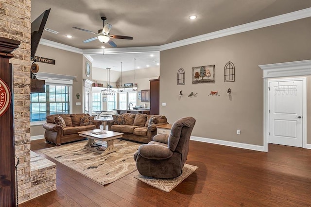 living room with crown molding, dark wood-type flooring, and ceiling fan