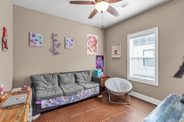 living room featuring hardwood / wood-style flooring and ceiling fan