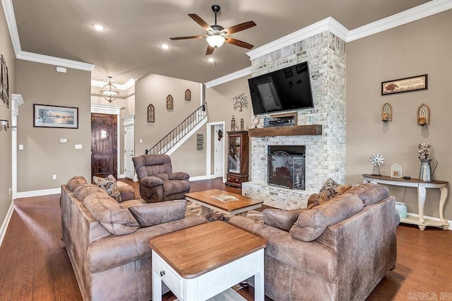 living room featuring crown molding, a fireplace, dark hardwood / wood-style floors, and ceiling fan