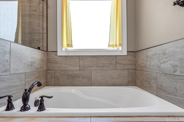 bathroom featuring a relaxing tiled tub