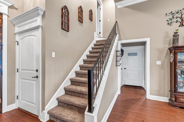 stairs with hardwood / wood-style flooring