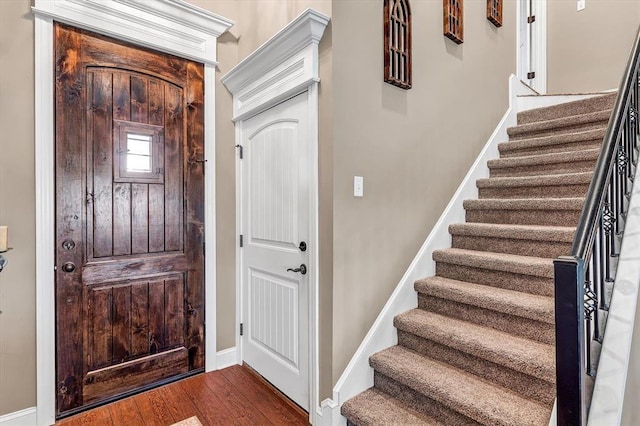 entryway with dark hardwood / wood-style floors