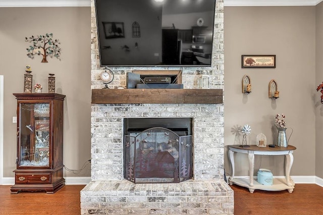 interior details featuring wood-type flooring and a brick fireplace