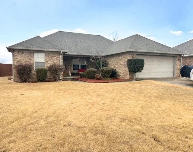 ranch-style house featuring a garage and a front yard