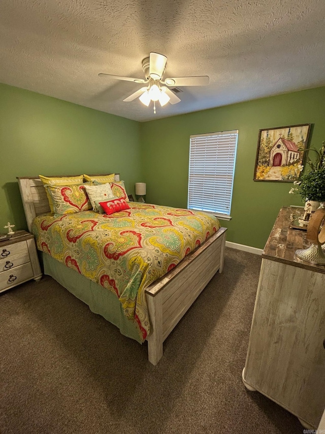 carpeted bedroom with a textured ceiling and ceiling fan