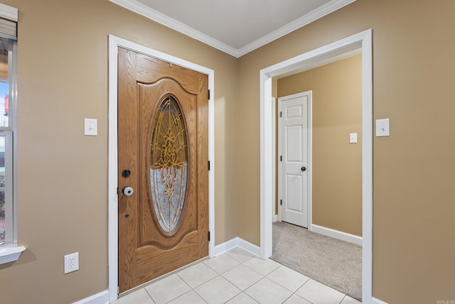 entrance foyer with light tile patterned floors and crown molding