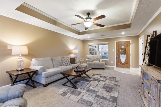 carpeted living room featuring crown molding, a textured ceiling, ceiling fan, and a tray ceiling