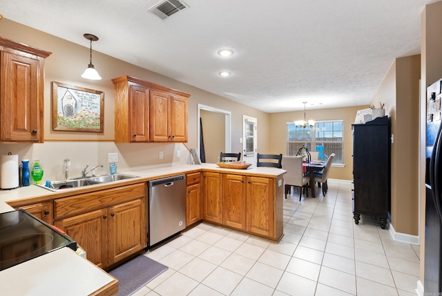 kitchen featuring pendant lighting, sink, kitchen peninsula, and appliances with stainless steel finishes