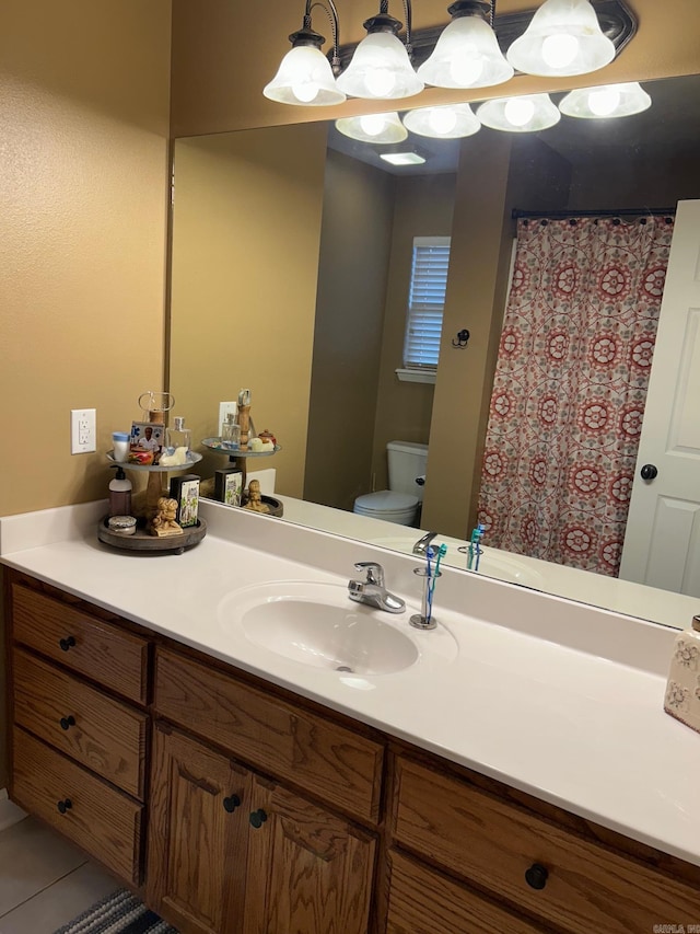 bathroom with vanity, tile patterned floors, and toilet