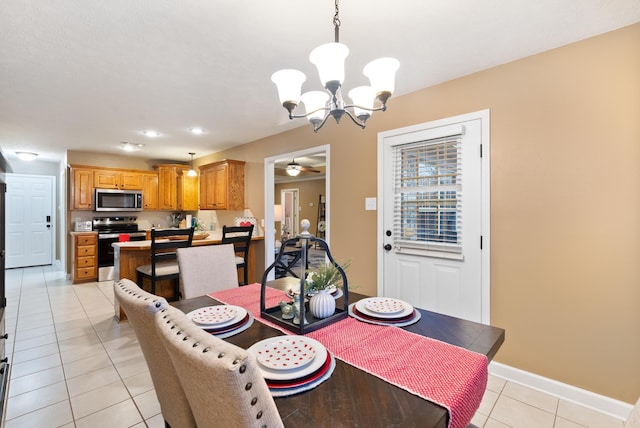 dining space featuring ceiling fan with notable chandelier and light tile patterned floors