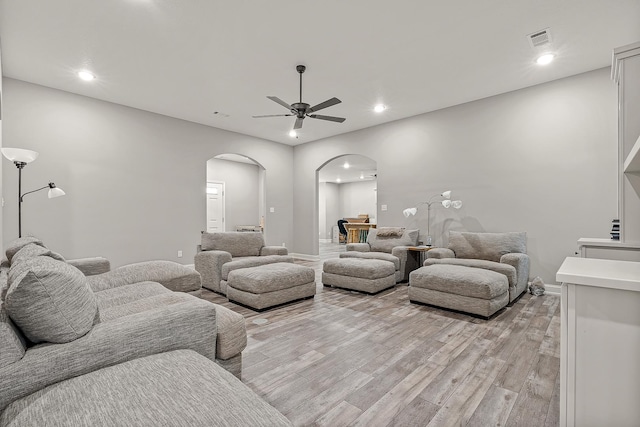 living room with ceiling fan and light wood-type flooring