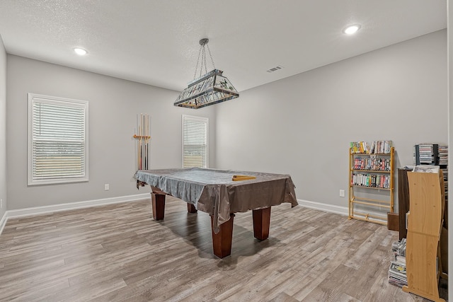 playroom featuring wood-type flooring, plenty of natural light, a textured ceiling, and billiards