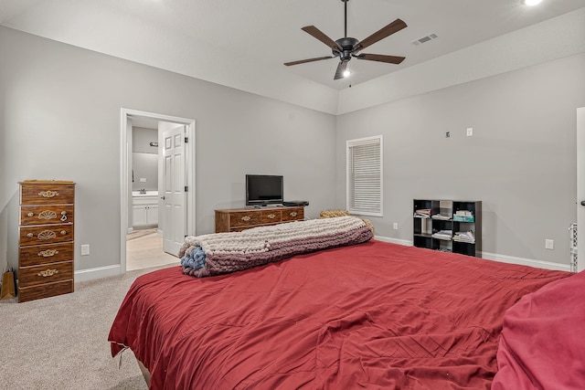 carpeted bedroom featuring vaulted ceiling, ceiling fan, ensuite bathroom, and sink