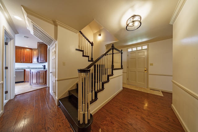 entrance foyer featuring crown molding and dark hardwood / wood-style floors