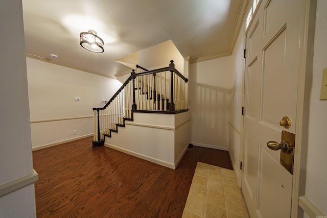 entrance foyer featuring ornamental molding and wood-type flooring