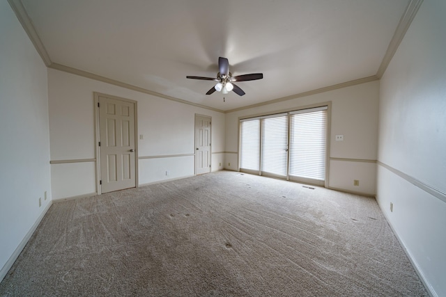 empty room featuring ceiling fan, ornamental molding, and carpet floors