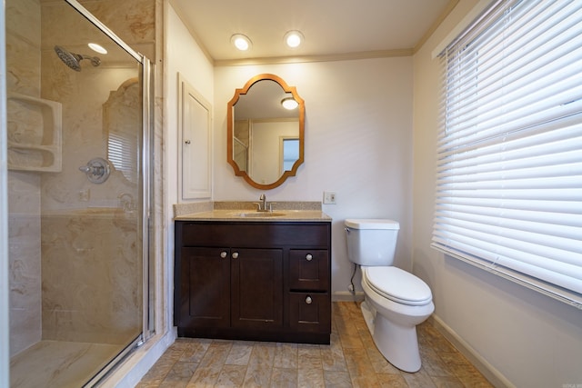 bathroom with vanity, an enclosed shower, crown molding, and toilet