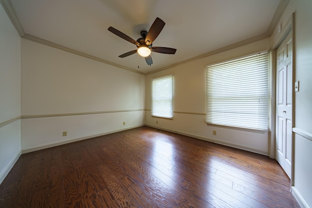 unfurnished room with crown molding, dark wood-type flooring, and ceiling fan