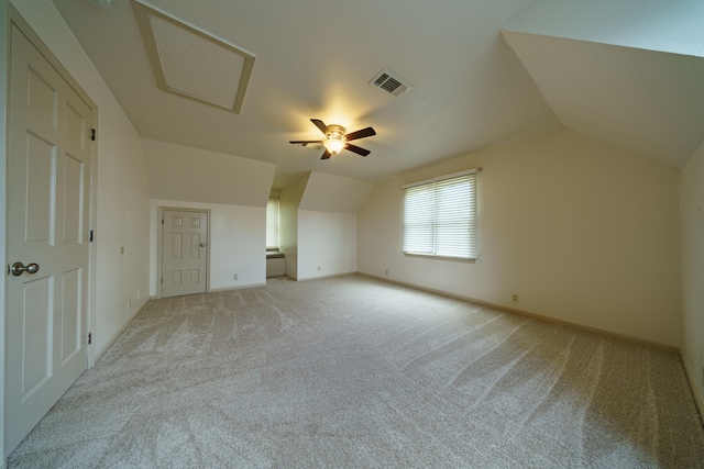 additional living space with vaulted ceiling and light carpet