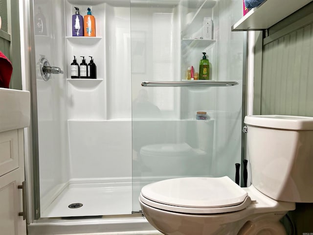 bathroom with walk in shower and toilet