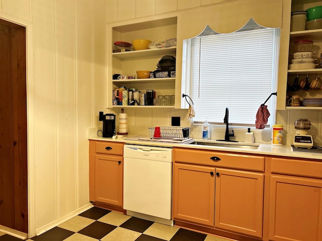 kitchen with sink, white dishwasher, and built in shelves