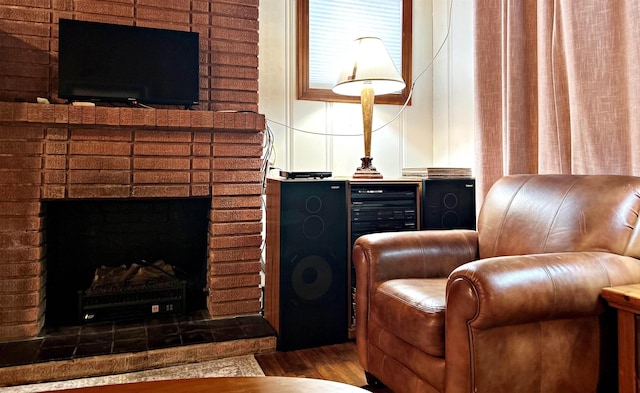 living area with hardwood / wood-style floors and a fireplace