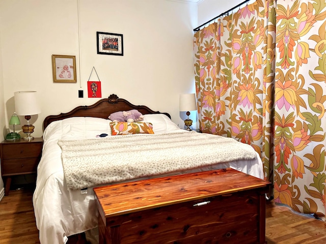 bedroom with dark hardwood / wood-style flooring