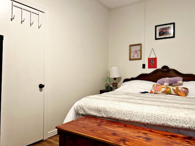 bedroom with hardwood / wood-style flooring