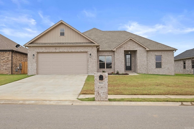 view of front of property with a garage and a front yard