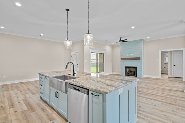 kitchen featuring pendant lighting, dishwasher, sink, ornamental molding, and a center island with sink