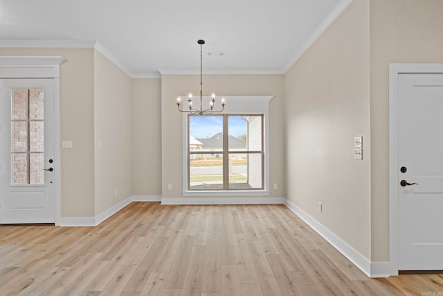 unfurnished dining area featuring crown molding, a chandelier, and light wood-type flooring