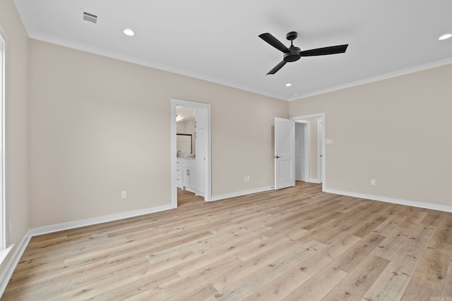 unfurnished bedroom with crown molding, connected bathroom, and light wood-type flooring