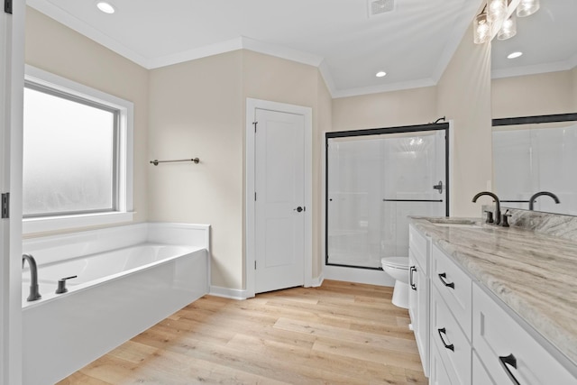 full bathroom featuring vanity, ornamental molding, hardwood / wood-style floors, and toilet