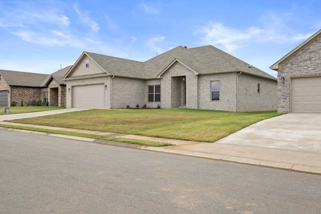 view of front of house with a garage and a front lawn