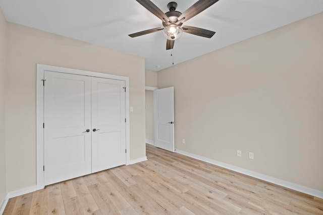 unfurnished bedroom with ceiling fan, light hardwood / wood-style floors, and a closet