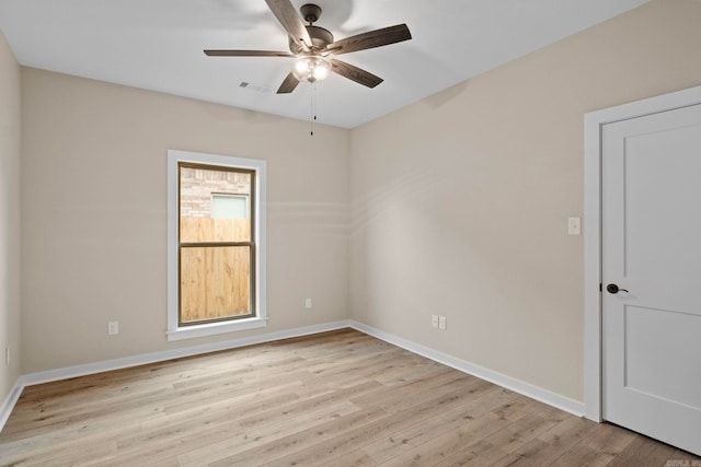 empty room with ceiling fan and light hardwood / wood-style floors