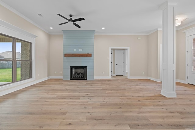 unfurnished living room with ceiling fan, ornamental molding, a fireplace, and light wood-type flooring