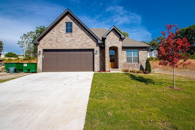 view of front of house with a garage and a front yard