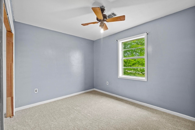 carpeted empty room featuring ceiling fan