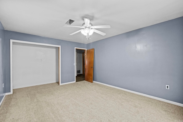 unfurnished bedroom with light carpet, ceiling fan, and a closet